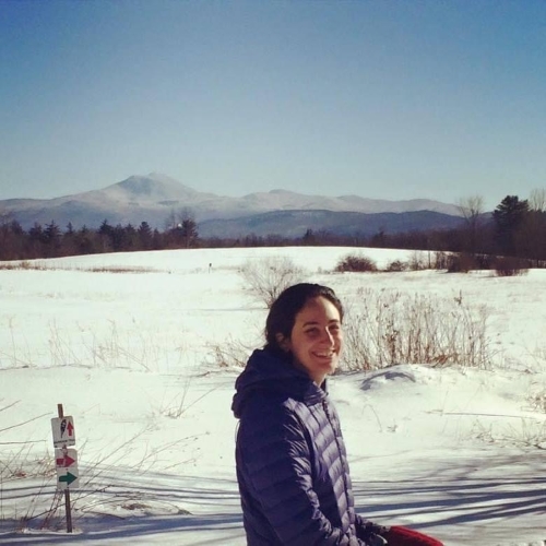 Liz Amler, snowy field and Camel's Hump peak in the distance